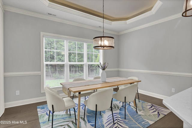 2233 Whiskey Branch Dr, Wilmington, NC 28409 - dining room featuring a tray ceiling, healthy amount of natural light, wood finished floors, and crown molding