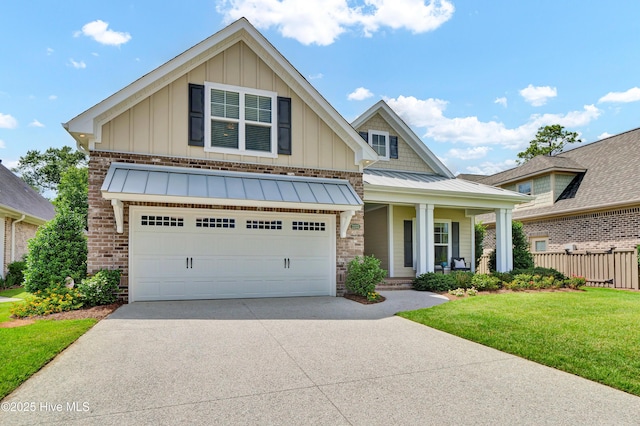 2233 Whiskey Branch Dr, Wilmington, NC 28409 - craftsman-style house featuring board and batten siding, driveway, covered porch, a standing seam roof, and brick siding