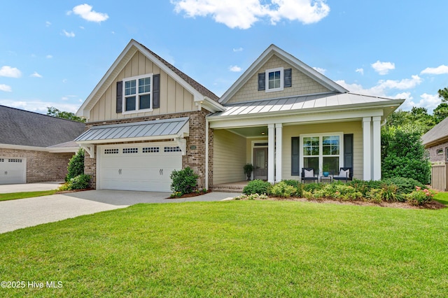 2233 Whiskey Branch Dr, Wilmington, NC 28409 - craftsman house featuring covered porch, driveway, a standing seam roof, and a front lawn
