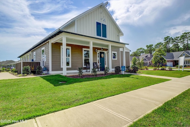 2233 Whiskey Branch Dr, Wilmington, NC 28409 - view of front of property with board and batten siding, a porch, and a front yard