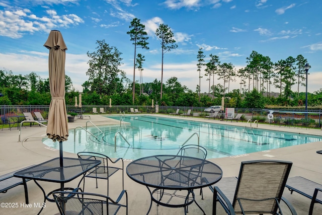 2233 Whiskey Branch Dr, Wilmington, NC 28409 - community pool with a patio and view of wooded area