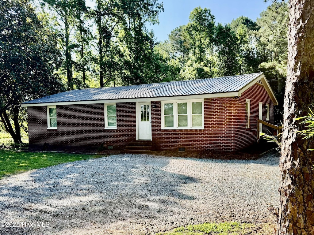 9433 NC Highway 53 E, Burgaw, NC 28425 - single story home with entry steps, crawl space, a metal roof, and brick siding