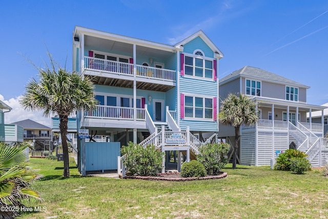 1726 W Beach Dr, Oak Island, NC 28465 - back of house with stairs and a lawn