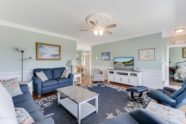 1726 W Beach Dr, Oak Island, NC 28465 - living area with crown molding, a ceiling fan, a wainscoted wall, and wood finished floors
