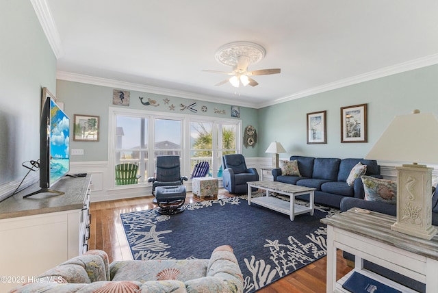 1726 W Beach Dr, Oak Island, NC 28465 - living room with wood finished floors, ornamental molding, ceiling fan, and wainscoting