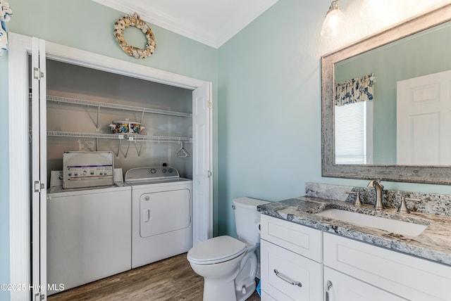 1726 W Beach Dr, Oak Island, NC 28465 - bathroom with separate washer and dryer, ornamental molding, vanity, and wood finished floors