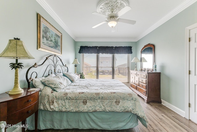 1726 W Beach Dr, Oak Island, NC 28465 - bedroom with ornamental molding, wood finished floors, and ceiling fan