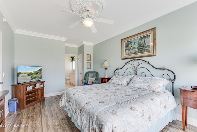 1726 W Beach Dr, Oak Island, NC 28465 - bedroom featuring wood finished floors, crown molding, ceiling fan, and ensuite bathroom