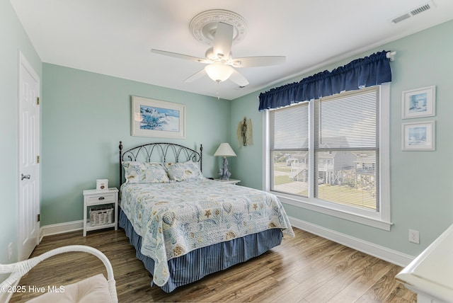 1726 W Beach Dr, Oak Island, NC 28465 - bedroom featuring wood finished floors and ceiling fan