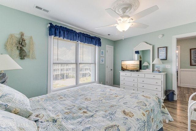 1726 W Beach Dr, Oak Island, NC 28465 - bedroom with wood finished floors and ceiling fan