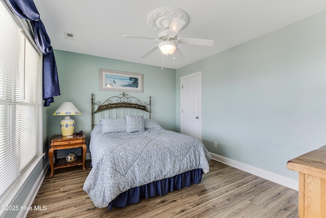 1726 W Beach Dr, Oak Island, NC 28465 - bedroom with wood finished floors and ceiling fan