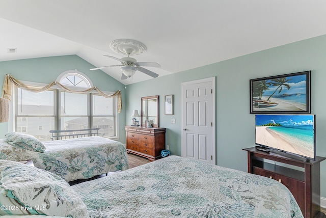 1726 W Beach Dr, Oak Island, NC 28465 - bedroom with wood finished floors, vaulted ceiling, and ceiling fan