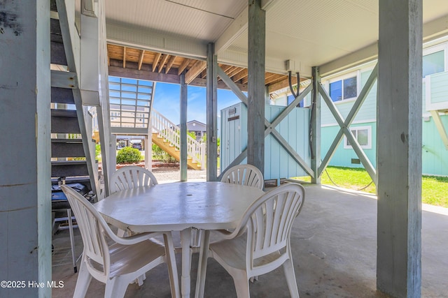 1726 W Beach Dr, Oak Island, NC 28465 - view of patio / terrace featuring stairs and outdoor dining area