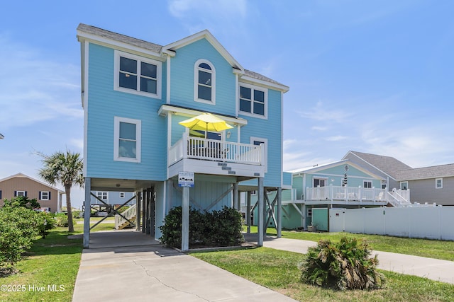 1726 W Beach Dr, Oak Island, NC 28465 - coastal inspired home featuring a carport, concrete driveway, and stairway