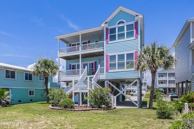 1726 W Beach Dr, Oak Island, NC 28465 - back of property featuring stairs, a balcony, and a yard