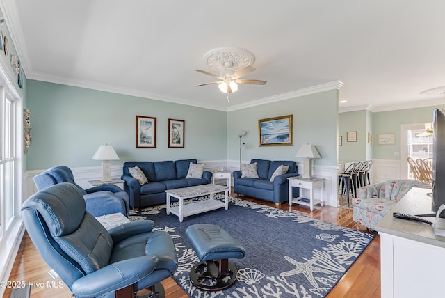 1726 W Beach Dr, Oak Island, NC 28465 - living area featuring ceiling fan, wood finished floors, ornamental molding, and wainscoting