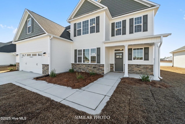 118 Sloth Ln, Jacksonville, NC 28546 - craftsman inspired home featuring stone siding, concrete driveway, a garage, and covered porch