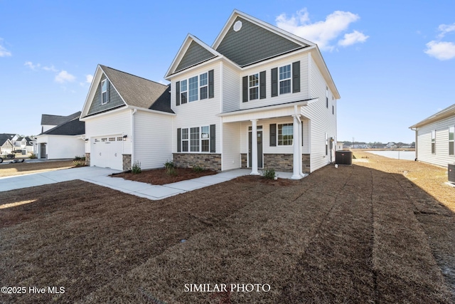 118 Sloth Ln, Jacksonville, NC 28546 - craftsman-style home featuring stone siding, concrete driveway, covered porch, and a garage