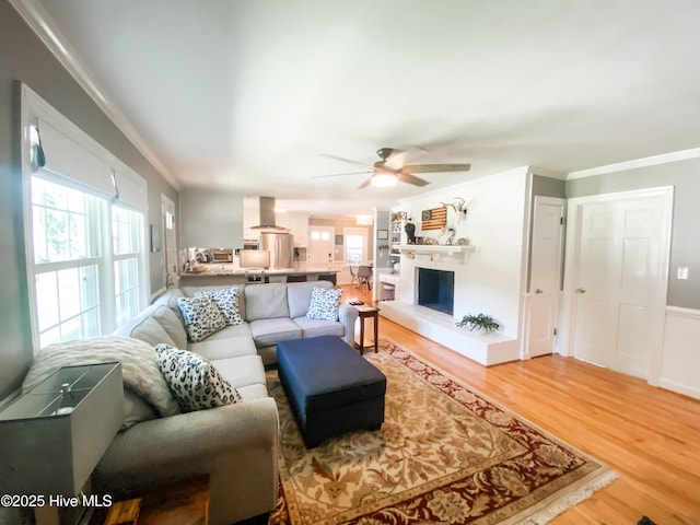1721 Nash St NW, Wilson, NC 27893 - living room with light wood-type flooring, ornamental molding, and ceiling fan