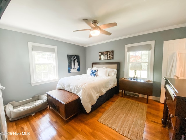 1721 Nash St NW, Wilson, NC 27893 - bedroom with wood finished floors, crown molding, and a ceiling fan