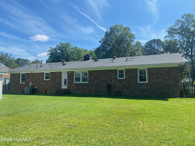 1721 Nash St NW, Wilson, NC 27893 - rear view of property featuring crawl space, brick siding, and a chimney