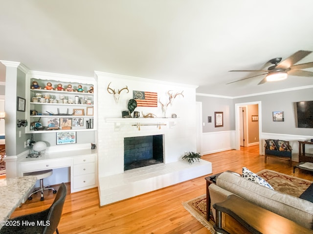 1721 Nash St NW, Wilson, NC 27893 - living area with crown molding, ceiling fan, a fireplace, light wood-style flooring, and an office area
