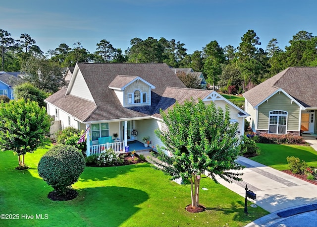 4875 Frasier Cir, Shallotte, NC 28470 - view of front facade featuring covered porch, a front lawn, and roof with shingles