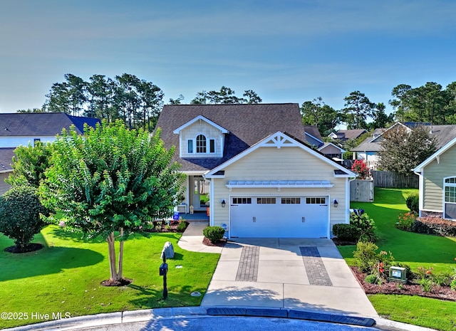 4875 Frasier Cir, Shallotte, NC 28470 - view of front of home with concrete driveway, an attached garage, and a shingled roof