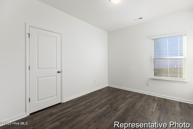 1664 Greenside Ct SW Unit 77, Ocean Isle Beach, NC 28469 - unfurnished room with dark wood-style floors and baseboards