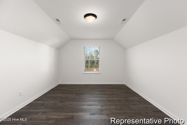 1664 Greenside Ct SW Unit 77, Ocean Isle Beach, NC 28469 - additional living space featuring dark wood-style flooring and vaulted ceiling