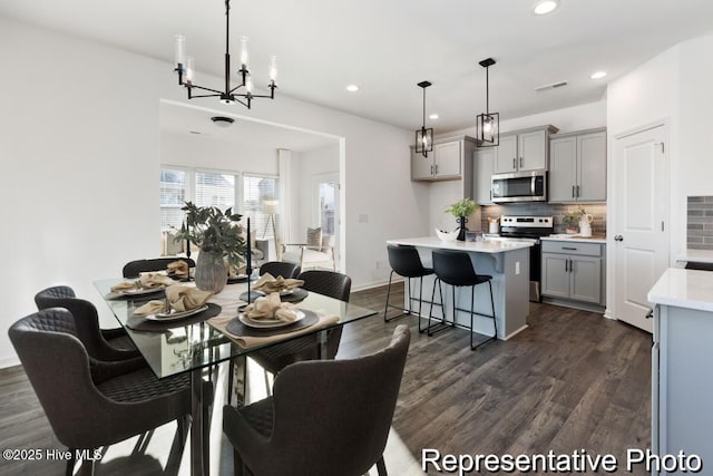 1664 Greenside Ct SW Unit 77, Ocean Isle Beach, NC 28469 - dining area with dark wood-style flooring, recessed lighting, and a chandelier