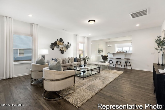1664 Greenside Ct SW Unit 77, Ocean Isle Beach, NC 28469 - living room featuring dark wood-type flooring, recessed lighting, and a chandelier