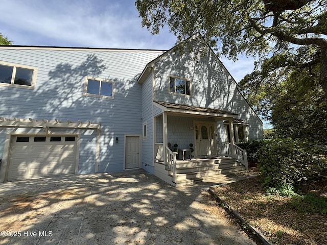 31 Augusta Dr, Oak Island, NC 28465 - view of front of house featuring a garage, concrete driveway, and a porch