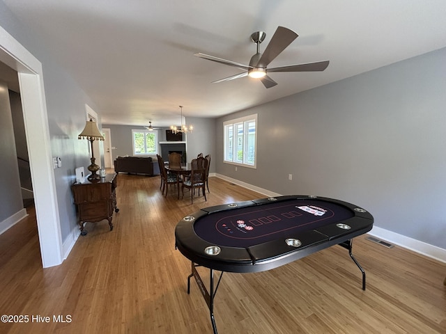 31 Augusta Dr, Oak Island, NC 28465 - rec room with a chandelier, ceiling fan, and wood finished floors