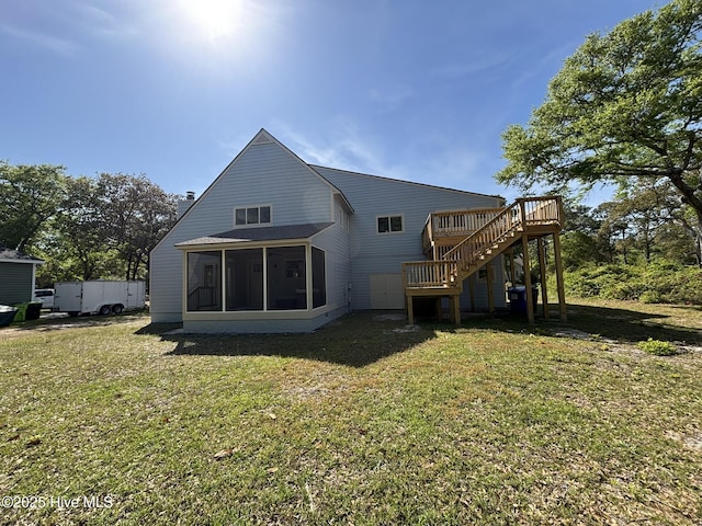 31 Augusta Dr, Oak Island, NC 28465 - back of property with stairway, a sunroom, a yard, and a wooden deck