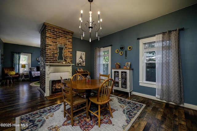 507 Blades Ave, New Bern, NC 28560 - dining space with a brick fireplace, a chandelier, plenty of natural light, and wood finished floors