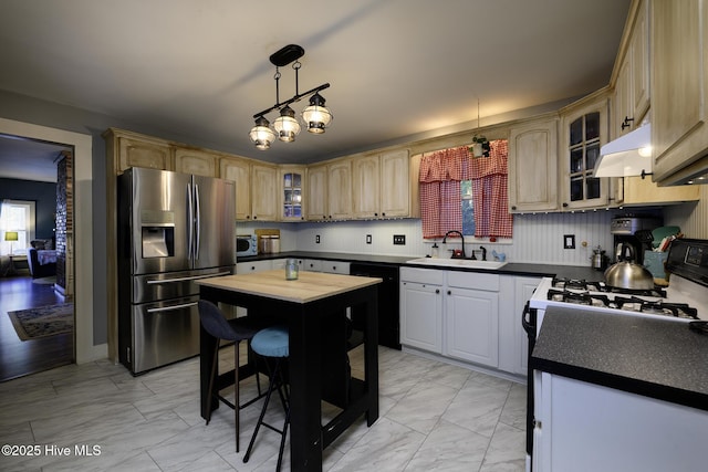 507 Blades Ave, New Bern, NC 28560 - kitchen with appliances with stainless steel finishes, light marble finish flooring, glass insert cabinets, and dark countertops