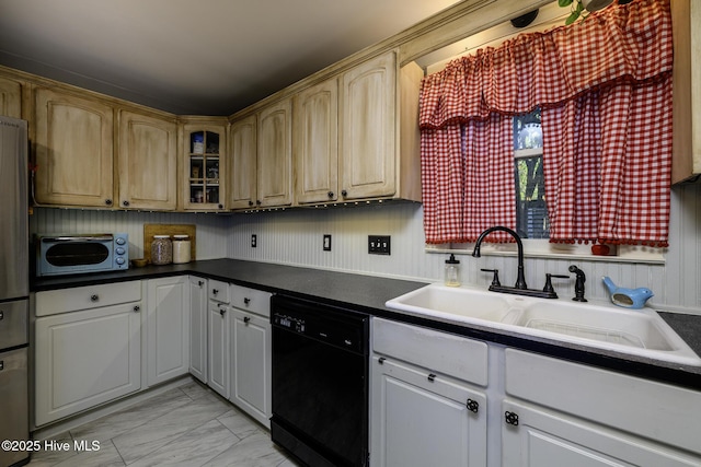 507 Blades Ave, New Bern, NC 28560 - kitchen with black dishwasher, light marble finish flooring, glass insert cabinets, dark countertops, and freestanding refrigerator