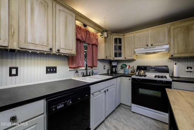 507 Blades Ave, New Bern, NC 28560 - kitchen with dishwasher, gas stove, under cabinet range hood, light marble finish floors, and dark countertops
