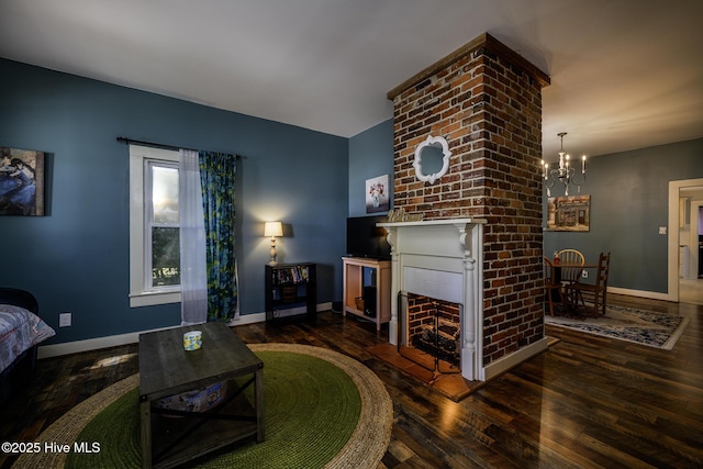 507 Blades Ave, New Bern, NC 28560 - living area featuring hardwood / wood-style floors, a brick fireplace, and a chandelier