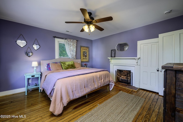 507 Blades Ave, New Bern, NC 28560 - bedroom with wood-type flooring, a fireplace, and ceiling fan