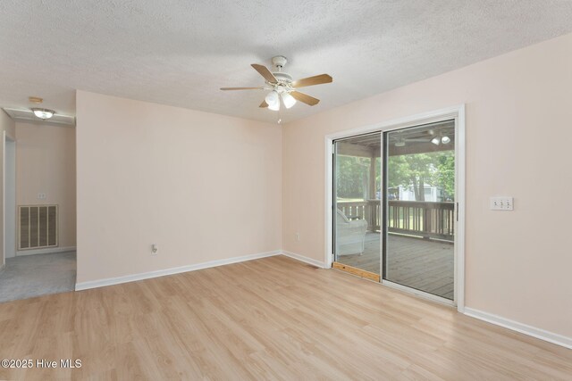 1901 Hess St, Wilmington, NC 28411 - empty room with light wood finished floors, a ceiling fan, and a textured ceiling