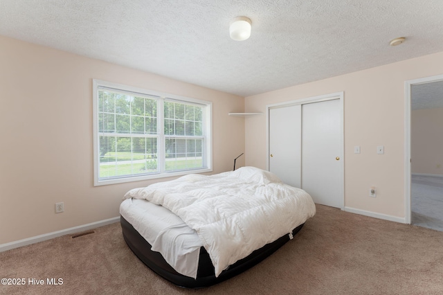 1901 Hess St, Wilmington, NC 28411 - carpeted bedroom featuring a closet and a textured ceiling