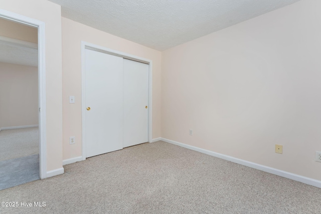 1901 Hess St, Wilmington, NC 28411 - unfurnished bedroom featuring carpet floors, a closet, and a textured ceiling