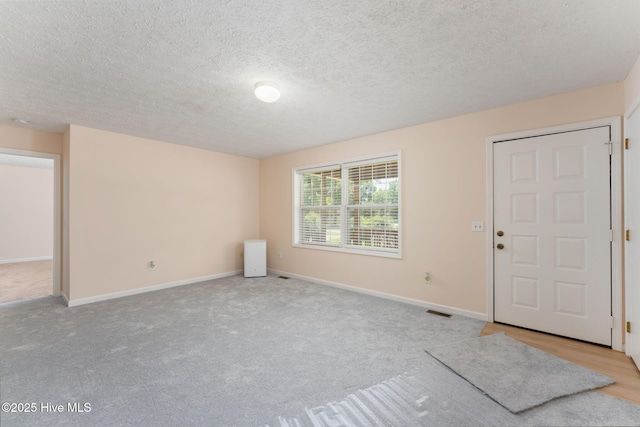 1901 Hess St, Wilmington, NC 28411 - carpeted entryway featuring baseboards and a textured ceiling