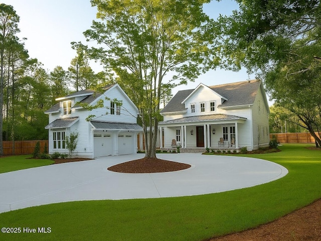 343 Pages Creek Rd, Wilmington, NC 28411 - view of front of home with a porch, an attached garage, a metal roof, concrete driveway, and a standing seam roof