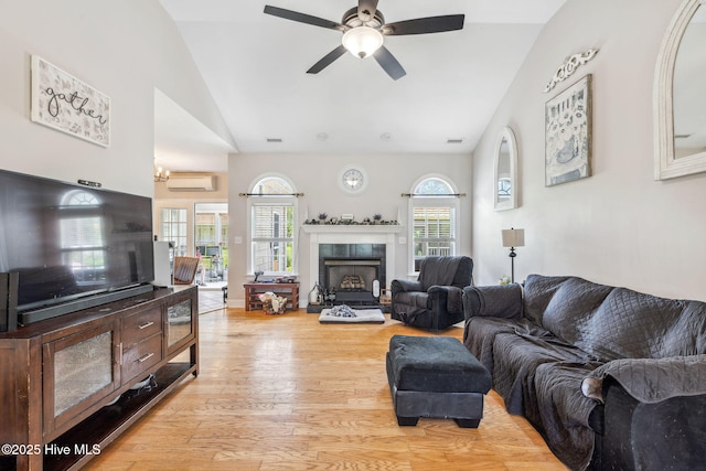820 Jackeys Creek Ln SE, Leland, NC 28451 - living room featuring an AC wall unit, light wood-style floors, ceiling fan, healthy amount of natural light, and high vaulted ceiling