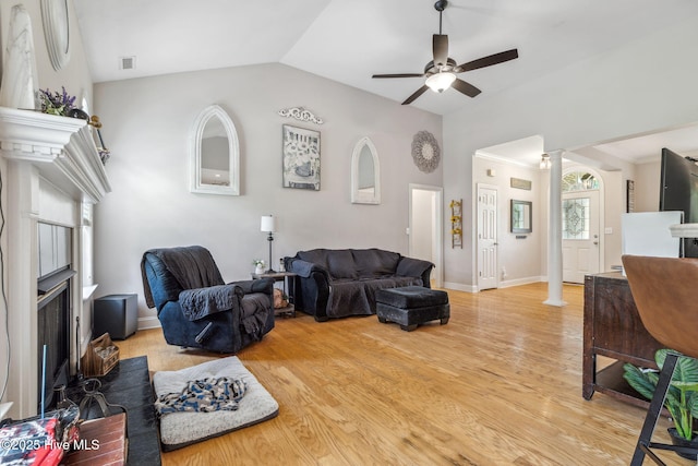 820 Jackeys Creek Ln SE, Leland, NC 28451 - living area with decorative columns, vaulted ceiling, a ceiling fan, a fireplace, and light wood-style flooring
