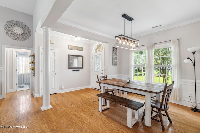 820 Jackeys Creek Ln SE, Leland, NC 28451 - dining area with crown molding, decorative columns, and light wood-style floors
