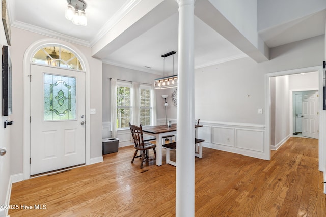 820 Jackeys Creek Ln SE, Leland, NC 28451 - entryway featuring decorative columns, light wood-style floors, wainscoting, ornamental molding, and a decorative wall
